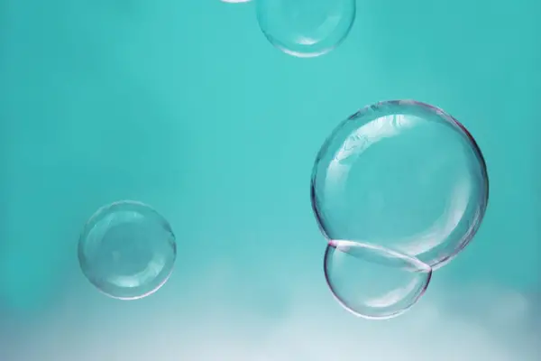 A photo of some water bubbles spitting in melted wax