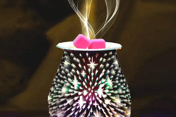 A photo of a wax melt smoking in a wax burner