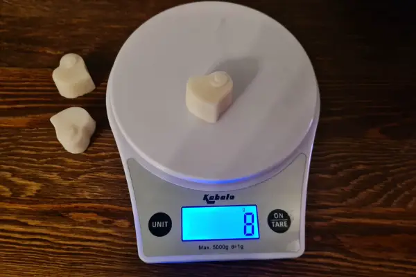 A photo of me weighing the wax melts for this experiment