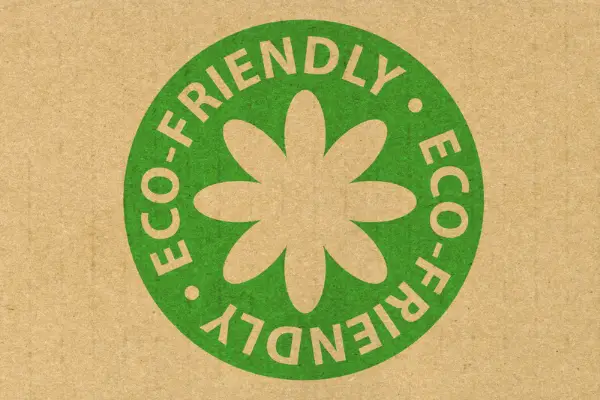 A photo showing an eco-friendly stamp on a soy wax candle package