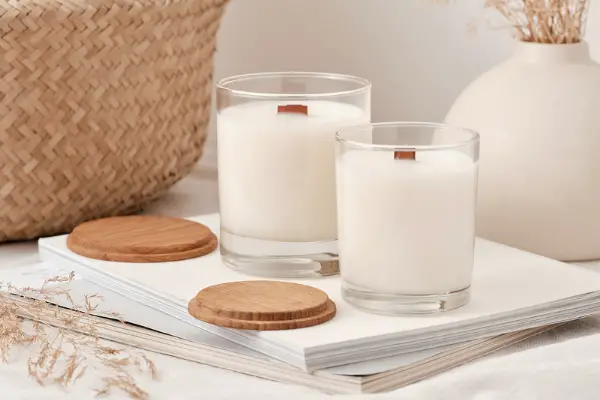 2 soy wax candles next to each other on a table