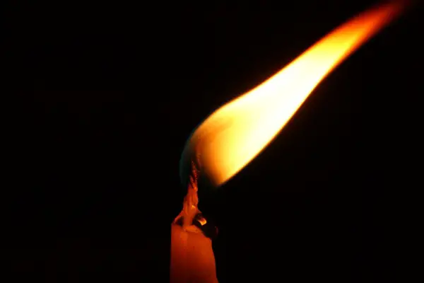 A photo of a candle flame flickering