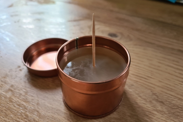 A photo of the toothpick wick in the wax candle cooling down