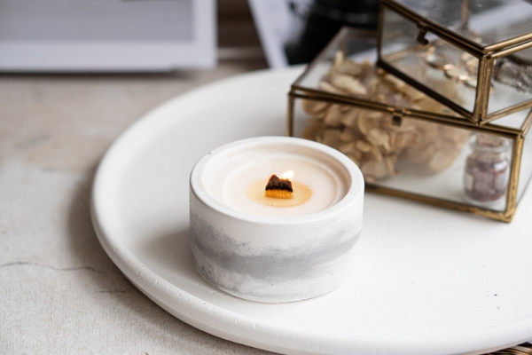 A photo of a soy wax candle with a single ply wooden wick