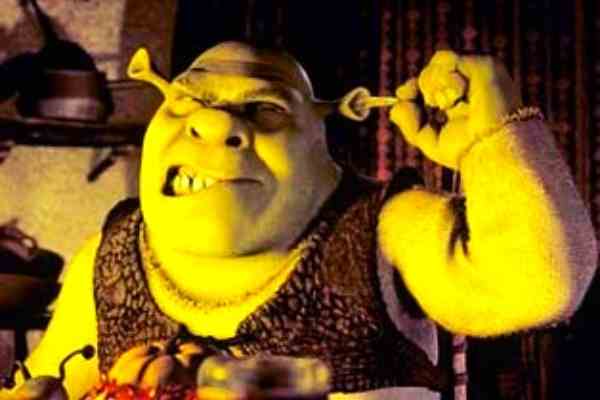 A photo of shrek the ogre making a candle out of his earwax