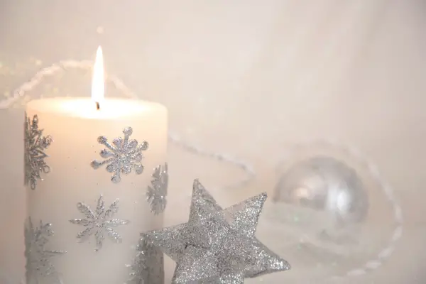 A photo of a candle coated in silver glitter