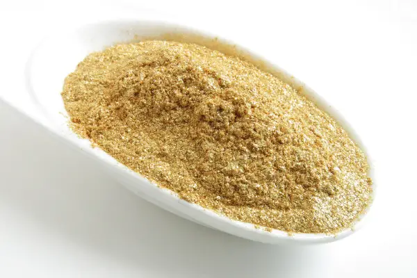 A photo of a spoonful of mica powder for candle making