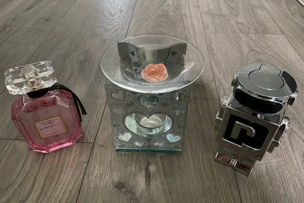 A photo of my wax warmer with perfumes next to it