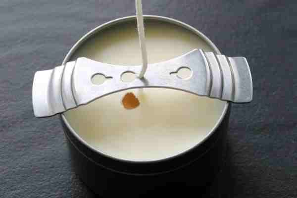 A photo of a soy wax candle with a sinkhole near the wick