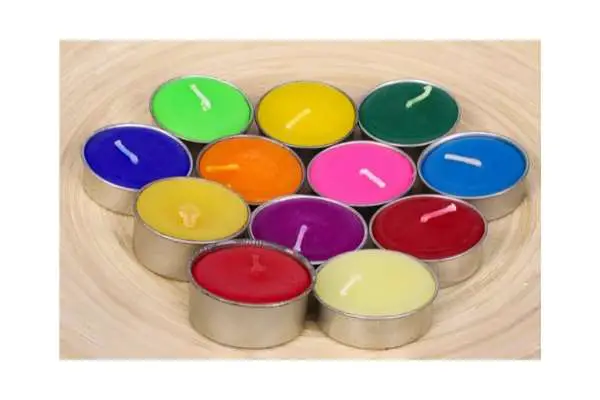 A photo of several small candles that have been dyed naturally