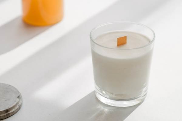 A photo of a soy wax candle that appears to be sweating