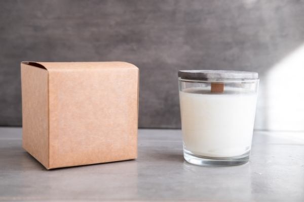 This photo shows a pure palm wax candle with a decorative box next to it