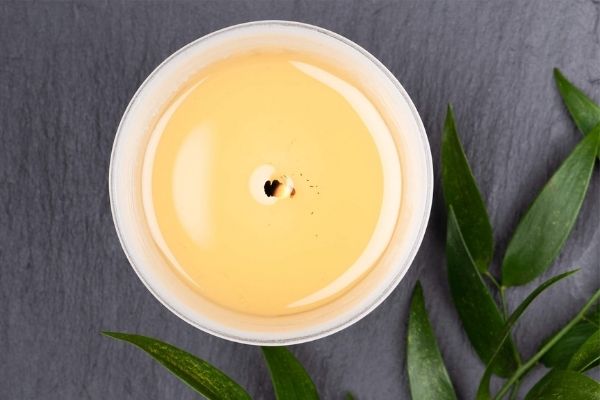 A photo of a soy candle that has a yellow hue