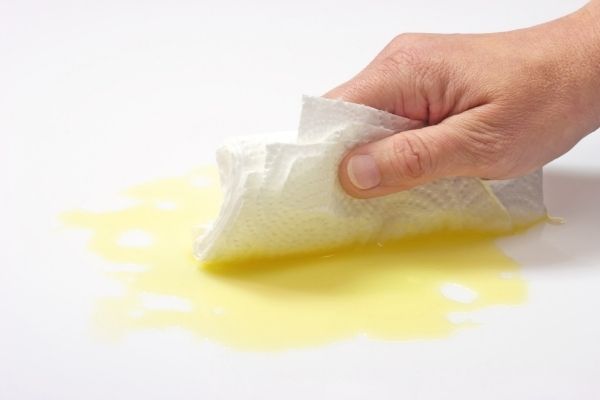 A photo of a spilled wax melts being cleaned of a surface
