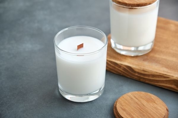 A photo of a soy wax candle curing with the lid on