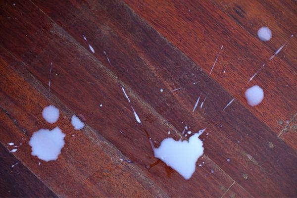 A photo of spilt scentsy wax on a wooden floor