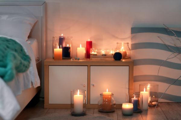 A photo of lots of candles in a small bedroom