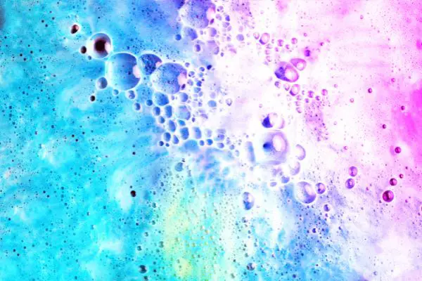 A close up photo showing the bubbles or froth created by a bath bomb.