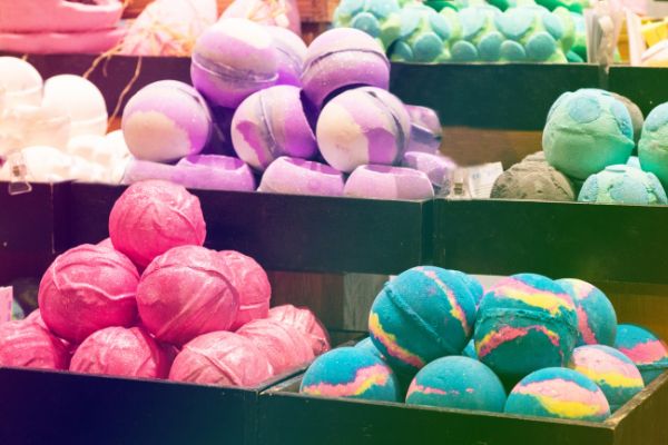 A photo of several shelves in a Lush store showing the different varieties of bath bombs that they stock.