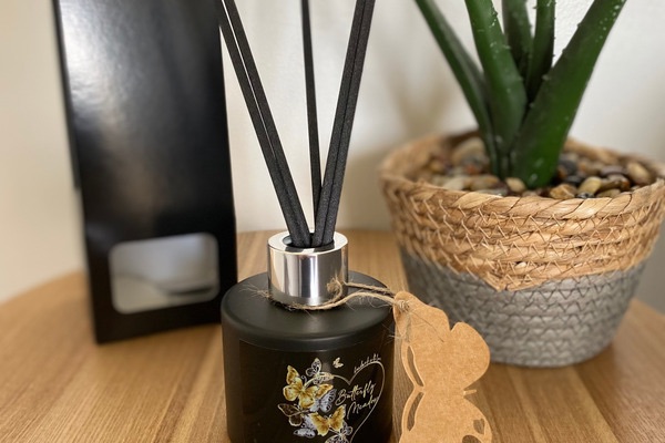 A photo of our home made reed diffusers and product packaging