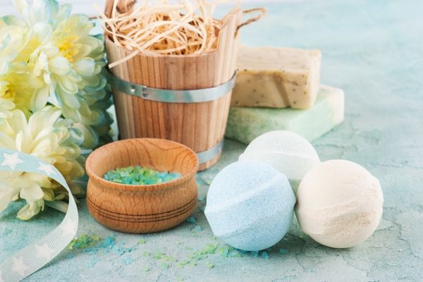 A photo of three bath bombs next to a bath